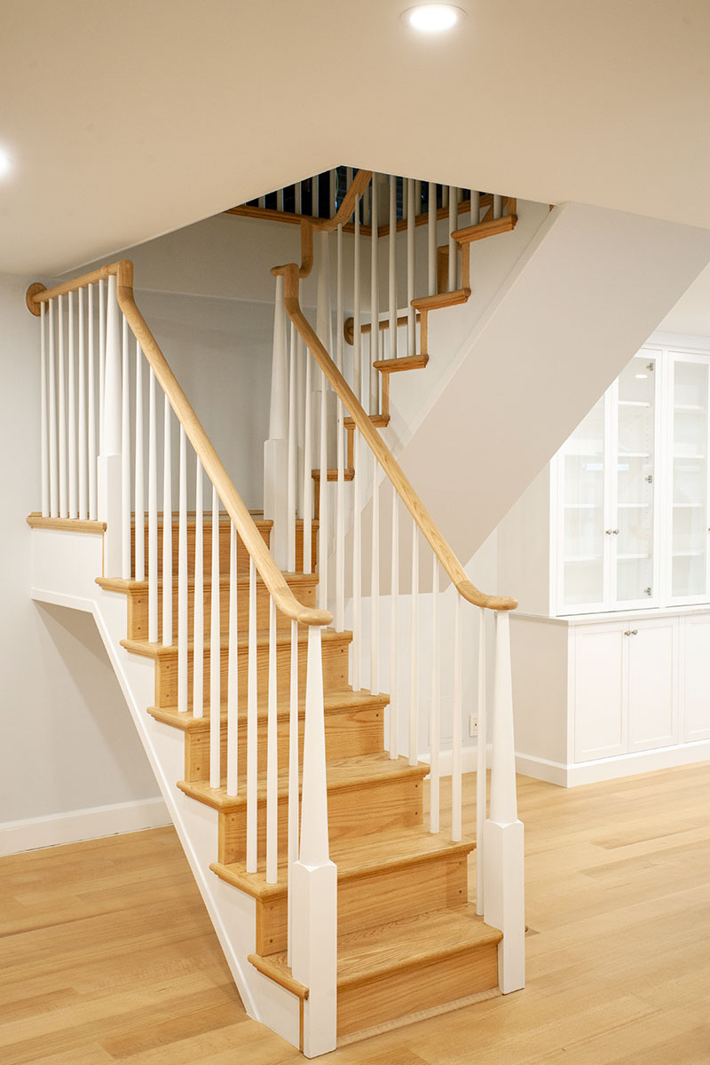 A custom red oak Stairway Remodel in A Partial Contemporary Renovation on the Upper West Side