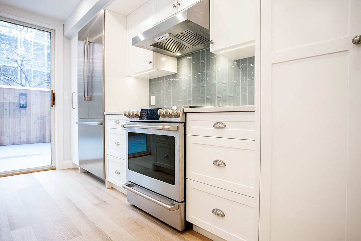 Vented Hood and gas range in a kitchen remodel that was part of a A Partial Contemporary Renovation on the Upper West Side by Paula McDonald Design Build & Interiors 