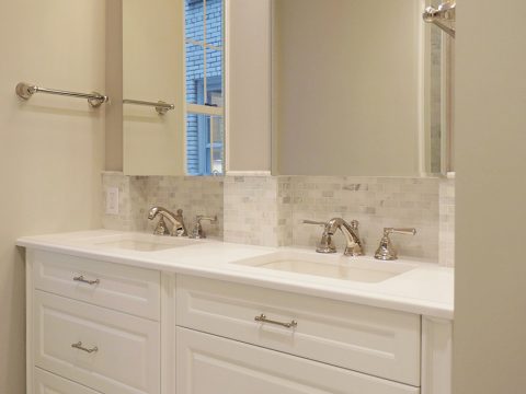 NYC apartment renovation featuring custom vanities